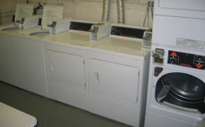 A pair of top-loading washing machines sit to the far left, a pair of front-loaders sit in the middle, and a stacked pair of front-loading dryers can be seen on the right.  They actually don't look like they're any different than normal washing machines.