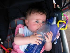 A photograph of six-month-old Carolyn clutching a water bottle to herself as if it were the most precious thing on Earth-- which, at that moment, it probably was.