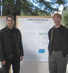 Tantek Çelik and Eric Meyer flank a conference poster presenting XFN.