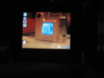A blurry image of the display panel of another digital camera, which shows that camera is pointed at the display panel of yet another digital camera.
