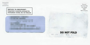 An image of a mailing envelope with the faint shadow of a credit card, as if it had been forced through rubber-wheel sorters or sat at the bottom of a very heavy sack of letters.