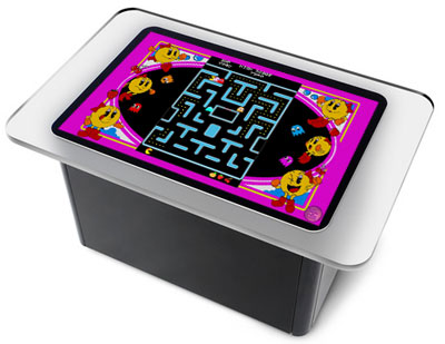 A picture of a Microsoft Surface unit with Ms. Pac-Man Photoshopped onto the display area, thus recalling the tabletop Ms. Pac-Man arcade games of yore.