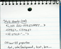 The top half of a loose-leaf spiral-bound notebook.  The page contains some simple notes about CSS, including the approximate number of properties and ways to associate CSS with HTML.