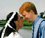 A picture of Eric and Kat in profile, touching noses and smiling.