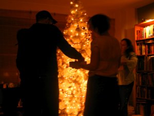 Adam Greenfield and Kat Meyer help Carrie decorate the Zeldmans' Christmas tree.